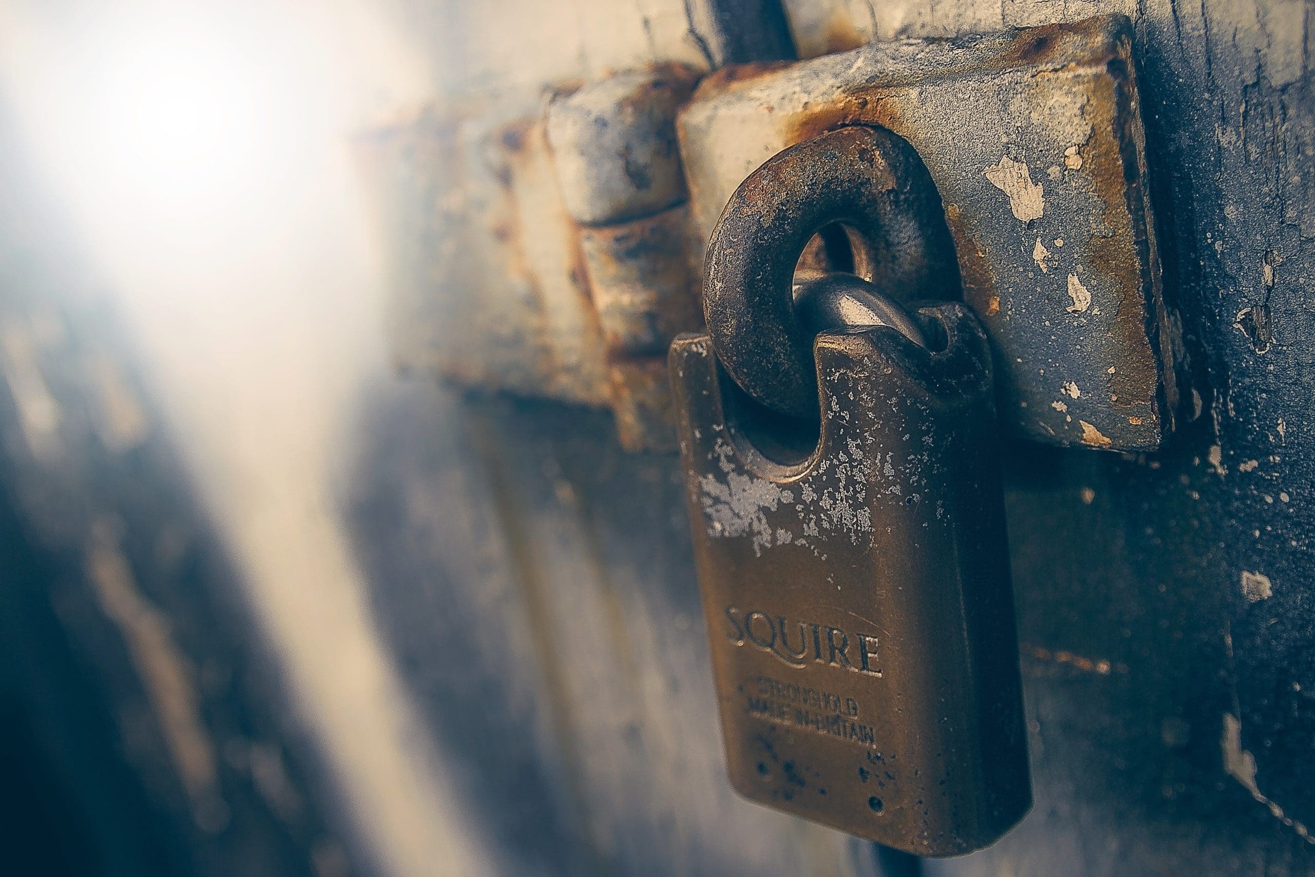 old door secured with a rusty padlock